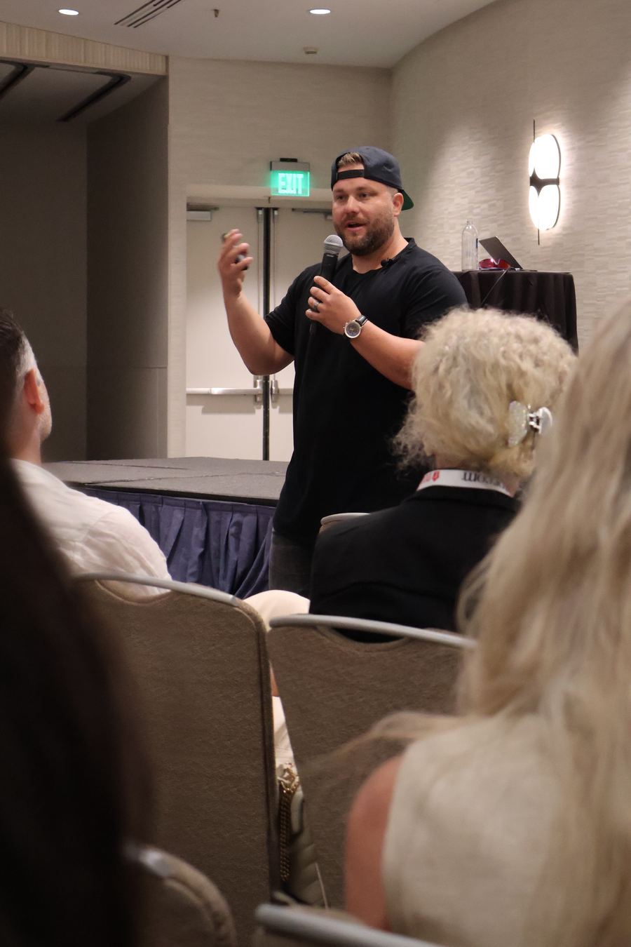 Jeremy speaking to an audience with a microphone