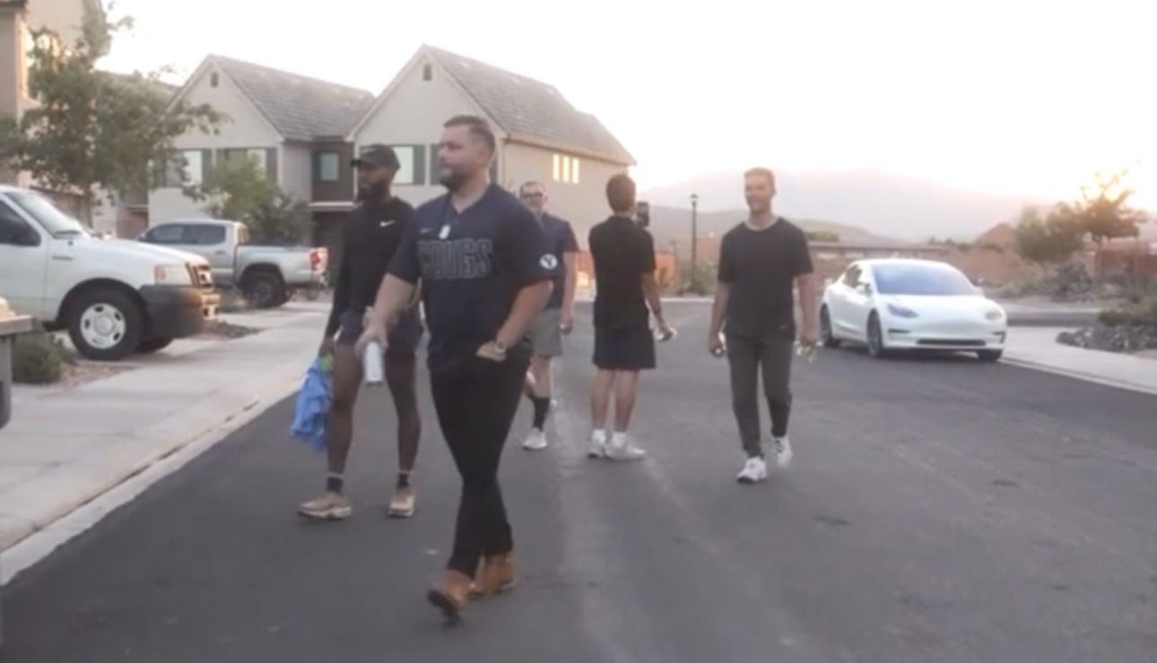 Jeremy Davis walking a neighborhood with a group of agents